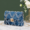 Small rectangular blue denim-look crossbody bag with a diamond-quilted pattern, frayed edges, gold-tone push-lock closure and gold-tone chain strap.