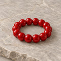 Candy Apple chunky red bead stretch bracelet on ivory lace with a gilded jewelry box and roses
