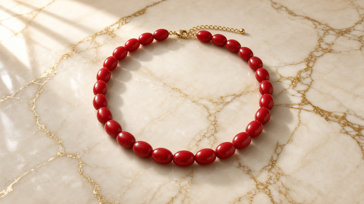 Candy Apple Game Day Necklace on cream marble with gold veining