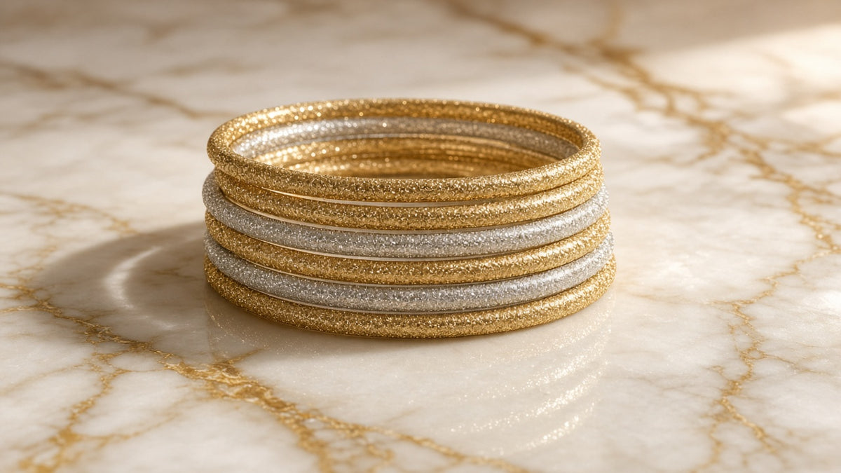 Champagne Glitter Jelly Bangle Stack (Set of 9) on cream marble with gold veining