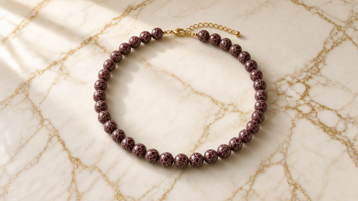 Crimson Heirloom Necklace on cream marble with gold veining