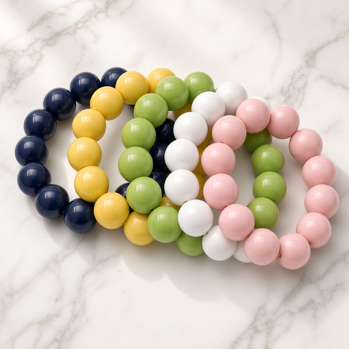 Color Block Chunky Bead Bracelets in assorted colors on white marble