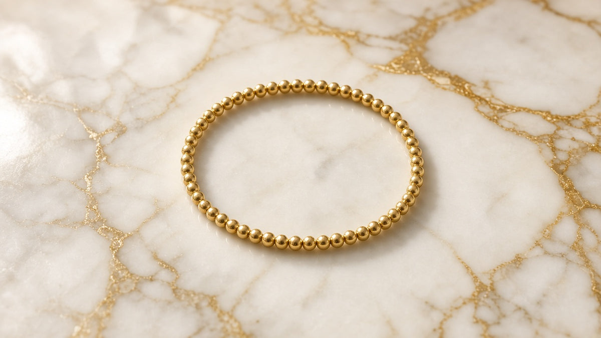 Gilded Cube Stretch Bracelet on cream marble with gold veining