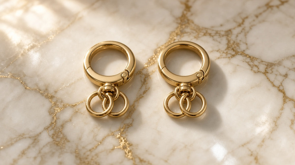 Golden Loop Swivel Bag Clips (2) on cream marble with gold veining