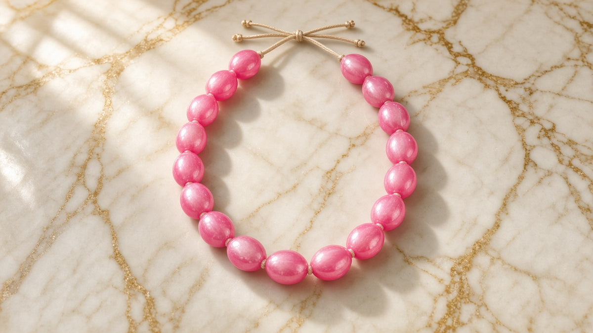 Pink Lemonade Chunky Bead Necklace on cream marble with gold veining