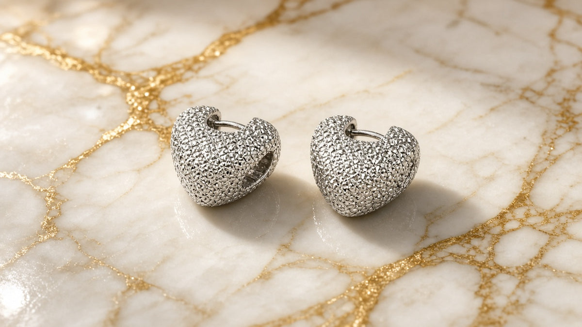 Silver Sweetheart Hoop Earrings on cream marble with gold veining